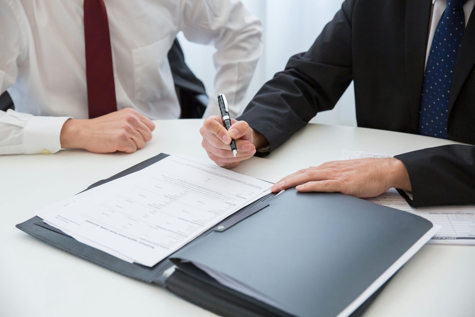 two people at desk looking over documents